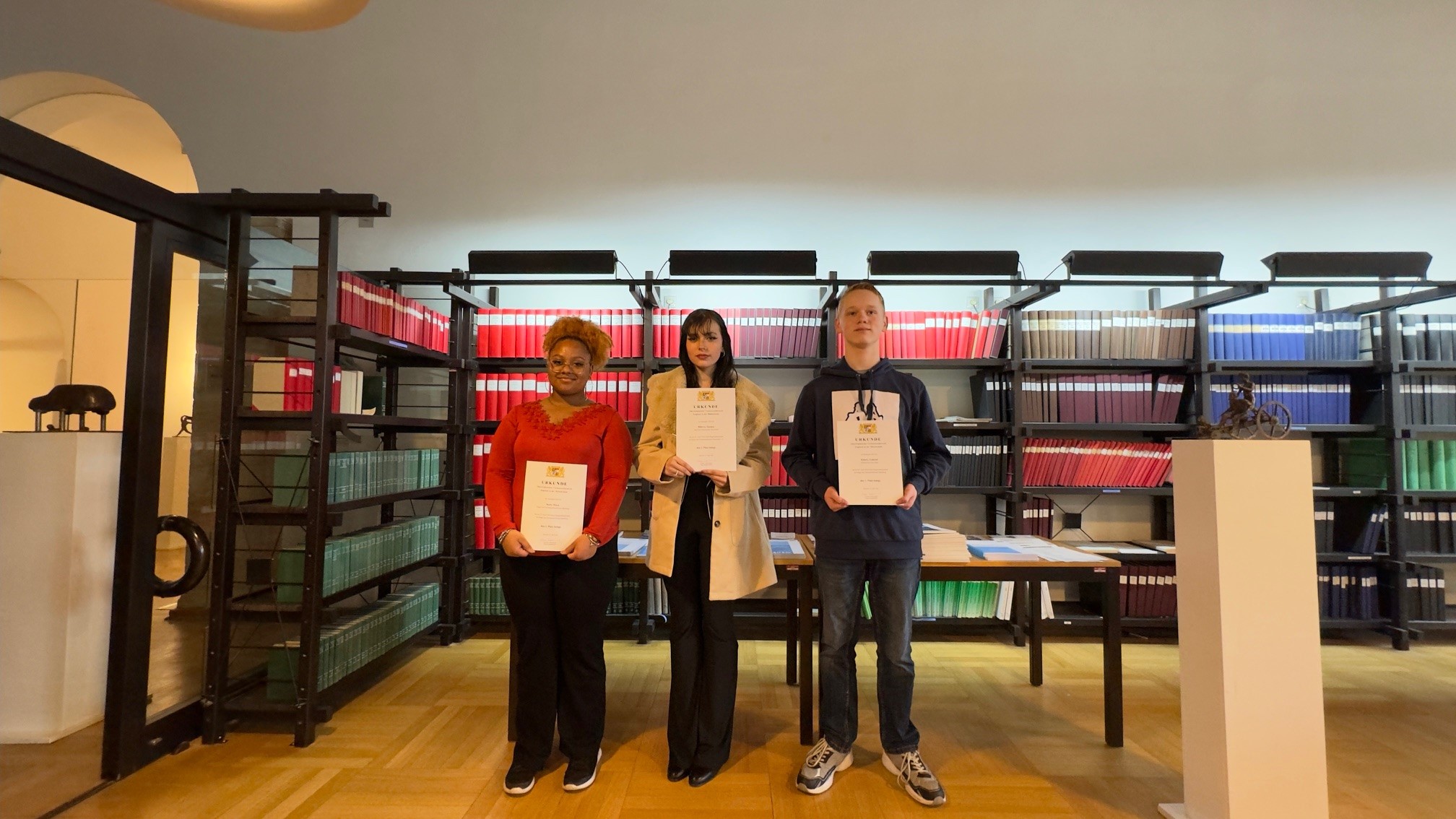 Die Siegerinnen und der Sieger des oberfränkischen Vorlesewettbewerbs in Englisch: v.l.n.r. Maja Scott (Platz 3), Zuzana Rihova (Platz 2), Gabriel Kinsey (Platz 1) Gruppenbild der drei Besten im oberfränkischen Vorlesewettbewerb in Englisch 2024